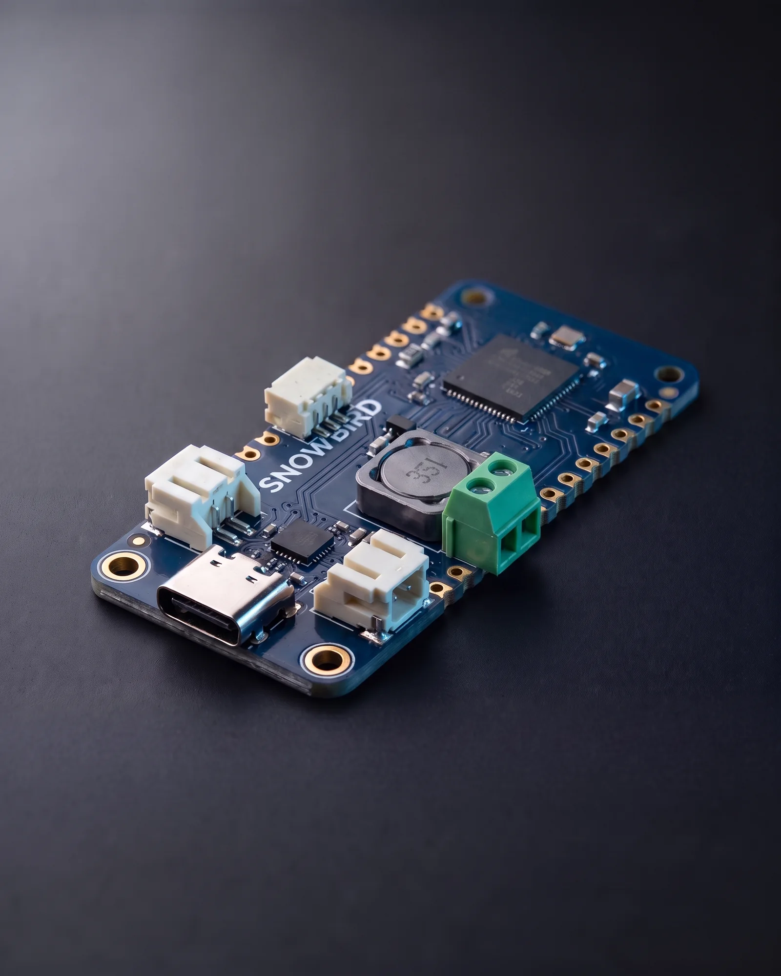 The Snowbird Lite 1S: a Feather-sized navy board like the Feather 1S but with a small bare microcontroller in place of the Bluetooth module.